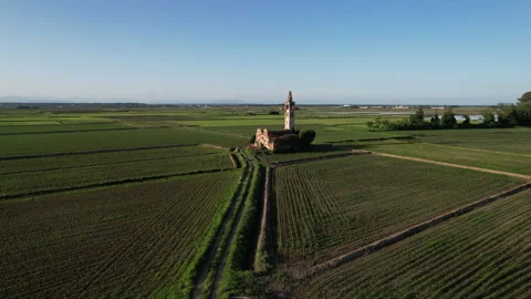 Spectacular medieval temple ruin surrounded by the paddy fields of Piedmont Stock Footage 247406828
