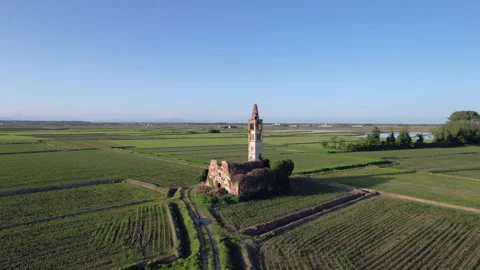 Spectacular medieval temple ruin surrounded by the paddy fields of Piedmont Stock Footage 247407019