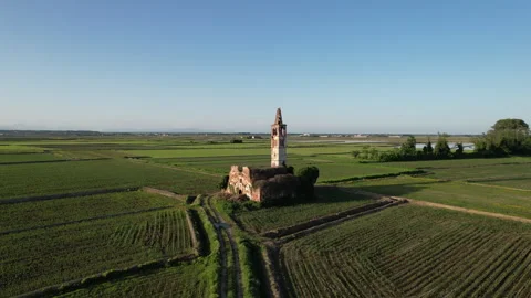 Spectacular medieval temple ruin surrounded by the paddy fields of Piedmont Stock Footage 247407053