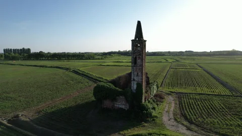 Spectacular medieval temple ruin surrounded by the paddy fields of Piedmont Stock Footage 247407410