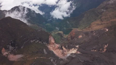 Spectacular Mountain Crater Surrounded by Clouds Stock Footage 345100306