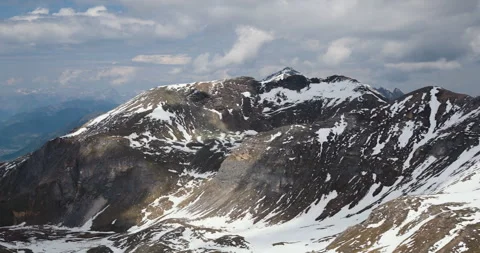 Spectacular mountain range with snow-capped peaks and dramatic skies in the Video stock 314082348