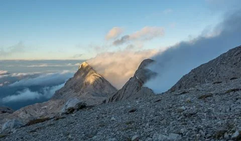Spectacular mountain view with evening clouds rolling over peaks and ridges. Stock Photos