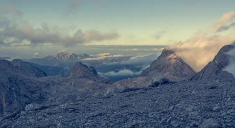 Spectacular mountain view with evening clouds rolling over peaks and ridges. Stock Photos