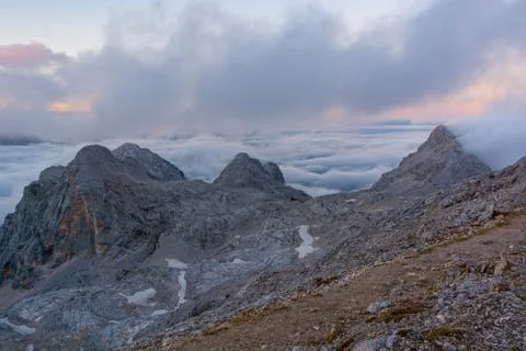 Spectacular mountain view with evening clouds rolling over peaks and ridges. Stock Photos