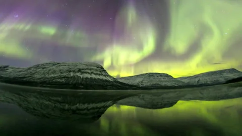 Spectacular northern lights dancing over snowy mountains Stock Footage 337021706