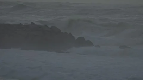 Spectacular Ocean Waves Crash Onto Ocean Shore After a Storm at Sunset Stockbeeldmateriaal 341684036