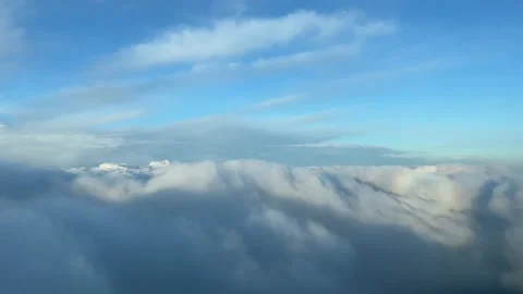 A spectacular pilot’s perspective: overflying just over the clouds with Stock Footage 237977490