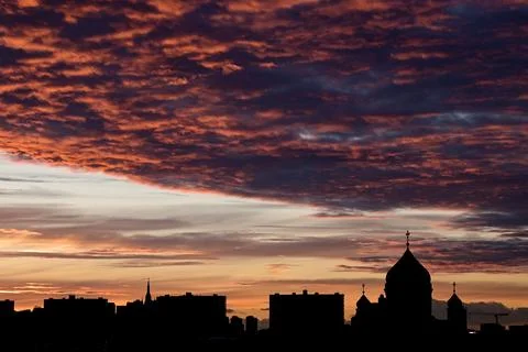Spectacular red clouds over a dark city Stock Photos