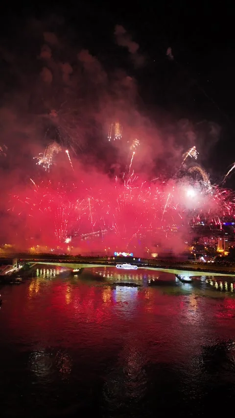 Spectacular Red Fireworks Exploding Over River in Bangkok, Thailand Stock Footage 335970156