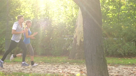 Spectacular Slow-Mo Of Athletic Young Couple Jogging After Work Stock Footage 42162546