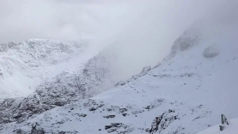 Spectacular snow clouds rolling through an aerial view of Snowdonia 動画素材 146803570