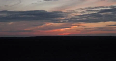 Spectacular sunset over field with clouds. Day to night time time lapse Stock Footage 138657943