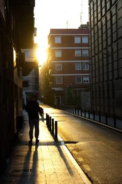 Spectacular sunset with the sun getting between the buildings Stock Photos