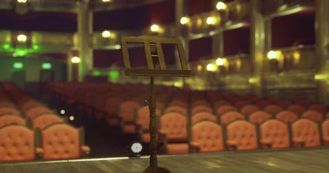 Spectacular theater interior featuring an empty stage with a music stand Stock Illustration