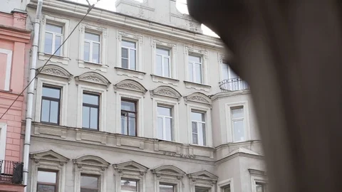 Spectacular view of old beige building with several windows and rain gutter pipe Stock Footage 107111644