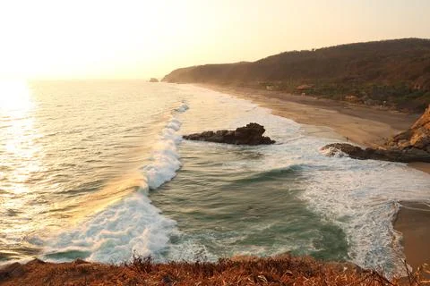 Spectacular view from the view point Punta Cometa, a big foamie wave is rolli Stock Photos