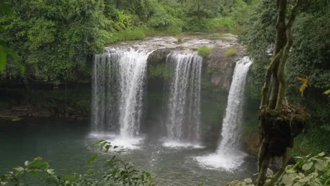Spectacular waterfall between the trees in the rainforest in Laos Stock Footage 236575176