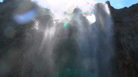 Spectacular Waterfall View Under the Cliff, Suns Flare, Slow Motion Stock Footage 146328893