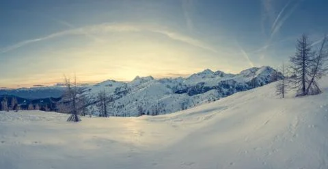 Spectacular winter mountain panoramic view of mountains at sunset. Stock Photos