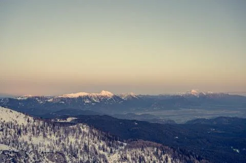 Spectacular winter mountain panoramic view of mountains at sunset. Stock Photos