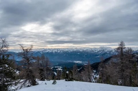Spectacular winter mountain panoramic view of mountains with clouded sky. Stock Photos