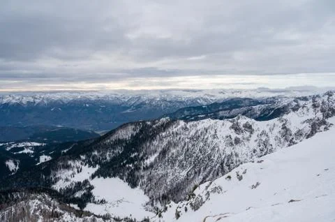 Spectacular winter mountain panoramic view of mountains with clouded sky. Stock Photos