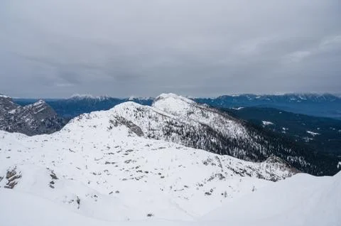 Spectacular winter mountain panoramic view of mountains with clouded sky. Stock Photos