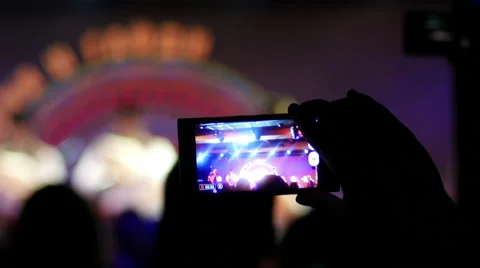 Spectator take a video via smartphone camera of a concert performance Stock Footage 57467217