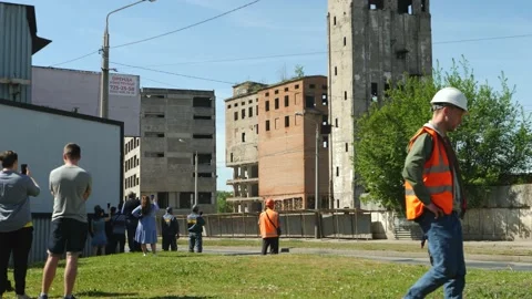 Spectators and workers are preparing to blow up building Stock Footage 154256219