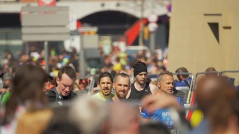 Spectators crowded waiting and watching the runners at the finish line of a m Stock Footage 109606052