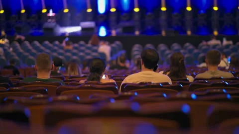 Spectators in half-empty hall waiting for beginning of performance Stock Footage 253061429