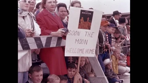 Spectators holding banner for astronauts Stock Footage 263418669