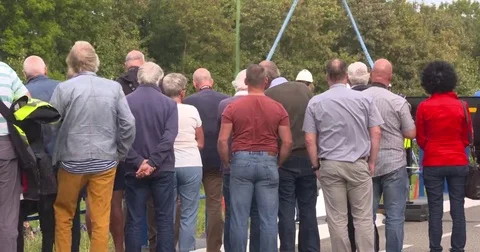 Spectators looking at hoisting activities, shot taken from behind Vídeo Stock 69256537