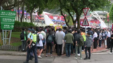 Spectators queue in line to enter the stadium holding the Hong Kong Seven Stock Footage 227627633