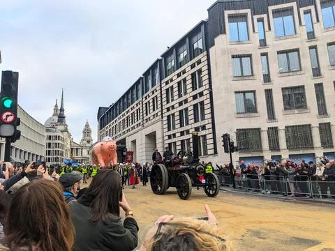 Spectators watch a pig float and steam engine during the Lady Mayors Show parade Stock Photos