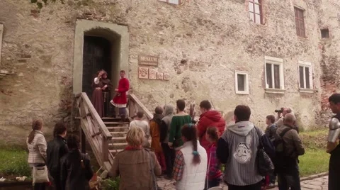 Spectators watch the wedding staged at the door of the castle Stock Footage 46701449