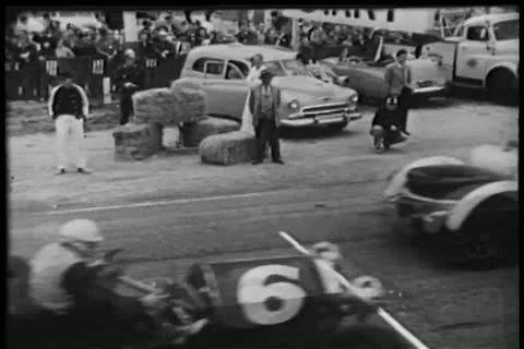 Spectators watching car race Stock Footage