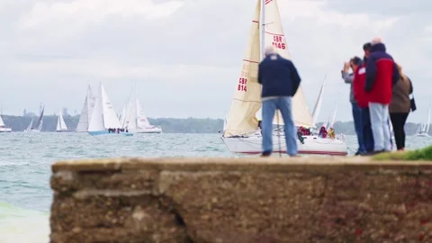 Spectators watching Yachts Passing 2025 Round the Island Race Isle of Wight Stock Footage 337936538