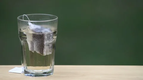 Sped up brewing of sun black tea with a shallow depth of field and copy space Stock Footage 94662047