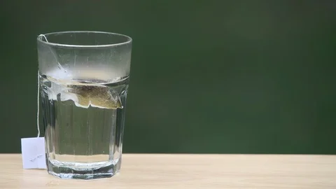 Sped up brewing of sun green tea with a shallow depth of field and copy space Stock Footage 94662064