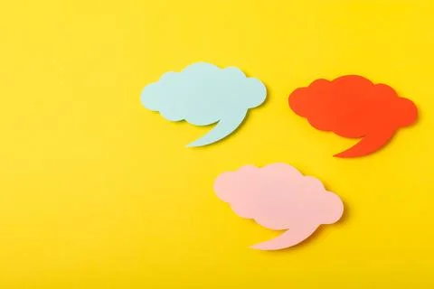 Speech bubble on a bright colored background. Stock Photos