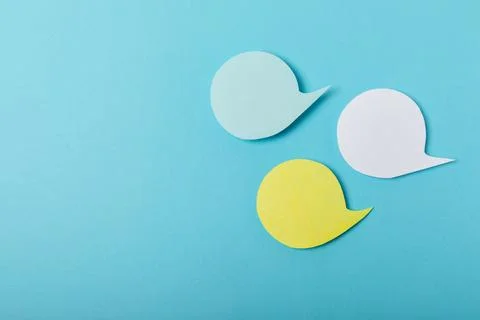 Speech bubble on a bright colored background. Stock Photos