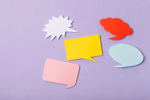 Speech bubble on a bright colored background. Stock Photos