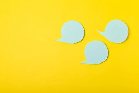 Speech bubble on a bright colored background. Stock Photos