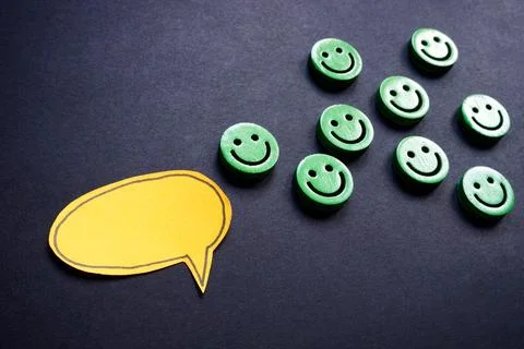 Speech bubble with emojis behind it. Communication concept. Stock Photos
