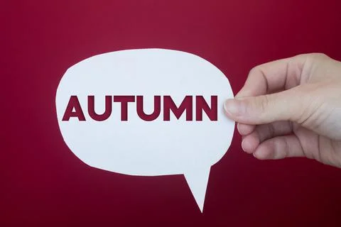 Speech bubble in front of colored background with Autumn text. Stock Photos