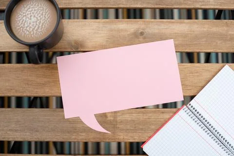 Speech Bubble With Important Message On Table With Coffee And Opened Notebook Stock Photos
