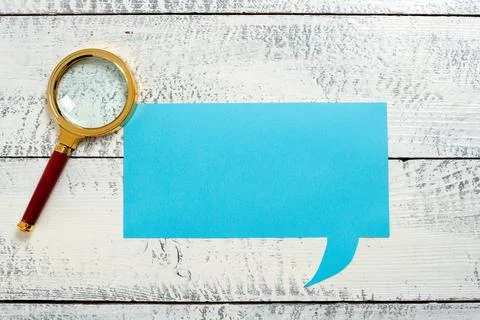 Speech Bubble With Important Messages Next To Magnifier On Floor. Dialogue Stock Photos