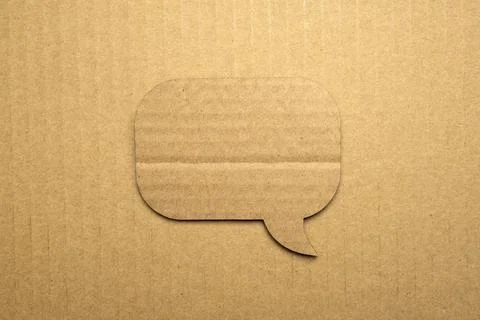 Speech bubble paper on cardboard background Stock Photos